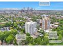 Beautiful aerial view of the building, featuring a sun terrace overlooking Cheesman Park and an enclosed pool, with Downtown Denver in the background at 1200 N Humboldt St # 604, Denver, CO 80218