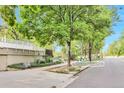 Street view of access to Cheesman Park with mature shade trees and lush foliage on a sunny day at 1200 N Humboldt St # 604, Denver, CO 80218
