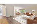 Bright living room with hardwood floors, large windows, and access to a dining area at 1200 N Humboldt St # 604, Denver, CO 80218