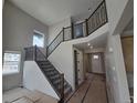 Grand foyer featuring high ceilings, hardwood flooring, a contemporary staircase, and ample natural light at 5591 Farrier Pt, Castle Rock, CO 80104