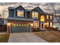 Charming two-story home with brick and siding, and a two-car garage at 9749 Newcastle Dr, Highlands Ranch, CO 80130