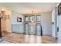 The foyer boasts wood floors and a decorative railing overlooking the front door at 6477 W Clifton Pl, Littleton, CO 80128