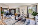 Cozy living room featuring hardwood floors and natural light from the large windows at 6477 W Clifton Pl, Littleton, CO 80128