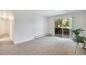 Spacious carpeted living room with sliding glass doors to a balcony allowing abundant natural light at 8050 Niwot Rd # 40, Niwot, CO 80503