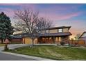 Inviting two-story home showcasing a well-manicured lawn and mature trees at 5270 Tabor St, Arvada, CO 80002