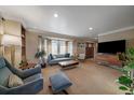 Spacious living room with large bay window, plush seating, and stylish decor at 5270 Tabor St, Arvada, CO 80002