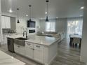 Bright, open kitchen with stainless steel appliances and an oversized island at 9642 E Idaho Pl, Aurora, CO 80247