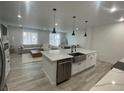 Open concept kitchen and living area with modern finishes and ample natural light at 9642 E Idaho Pl, Aurora, CO 80247