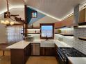 Updated kitchen featuring white subway tile backsplash and wood countertops at 3335 Dexter St, Denver, CO 80207