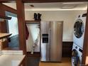 Laundry room with full-size washer, dryer, and refrigerator at 3335 Dexter St, Denver, CO 80207