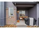 Cozy front patio with a table, chairs, and grill under a covered porch at 430 Millwall Cir, Castle Pines, CO 80108