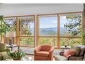 Living room showcasing bright windows with lush green mountain views at 1943 Columbine Ct, Golden, CO 80401
