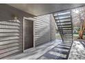 Condo building entryway with a private exterior door and stairs at 2575 S Syracuse Way # 108, Denver, CO 80231