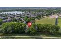Stunning aerial view of property with lake and community amenities and a park nearby at 1440 E 128Th Ct, Thornton, CO 80241
