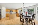 Spacious kitchen with light wood cabinetry, stainless steel appliances, and a center island for meal prep at 1440 E 128Th Ct, Thornton, CO 80241