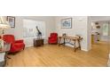 Bright living room featuring hardwood floors, two plush armchairs and modern decor at 1440 E 128Th Ct, Thornton, CO 80241