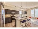 Modern kitchen with stainless steel appliances, granite countertops, and seating at the island at 2114 N Clay St, Denver, CO 80211