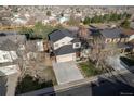 Overhead view of a two-story home with a two-car garage, a driveway, and mature trees at 2875 S Tower Way, Aurora, CO 80013