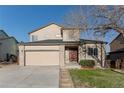 Charming two-story home with a two-car garage and nicely landscaped front yard at 2875 S Tower Way, Aurora, CO 80013