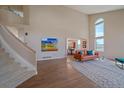 Spacious living room with soaring ceilings, large windows, hardwood floors, and a leather sofa at 21166 E Euclid Dr, Centennial, CO 80016