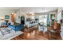 Open concept living and kitchen area featuring hardwood floors at 7256 Aspen Meadow Dr, Evergreen, CO 80439