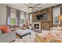 Comfortable living room with natural light, a rustic stone fireplace, and stylish decor at 6471 S Potomac Ct, Englewood, CO 80111