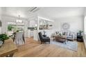 Bright, open-concept living room with hardwood floors, a view of the kitchen and a dining area at 2230 Niagara St, Denver, CO 80207