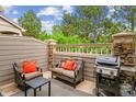 Cozy patio with stone accents, outdoor seating, and a grill, perfect for entertaining at 570 Clarendon Loop, Castle Pines, CO 80108