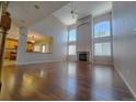 Spacious living room with hardwood floors, a fireplace, and large windows at 18874 E Ida Ave, Aurora, CO 80015