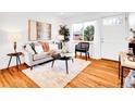Bright living room with wood floors, modern furniture, stylish decor, and plenty of natural light at 4201 Shoshone St, Denver, CO 80211