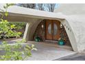 Unique dome home features a stone facade and a charming, covered front entrance with double doors at 6681 S Abilene Way, Centennial, CO 80111