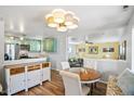 Cozy dining area featuring a round table, hardwood floors, and stylish lighting at 2170 W Warren Ave, Englewood, CO 80110