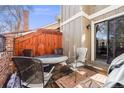 Cozy outdoor patio with brick flooring, wooden fence, and a table with seating for four at 11710 Elk Head Range Rd, Littleton, CO 80127