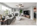Cozy living room with a fireplace, large windows, and stylish decor creating a welcoming ambiance at 16523 High Desert Pl, Parker, CO 80134
