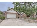 Front view of a brick ranch home with a two-car garage at 11275 Ranch Pl, Denver, CO 80234