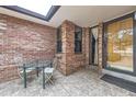 Brick patio with a small glass table and chairs at 11275 Ranch Pl, Denver, CO 80234