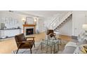 Cozy living room with a fireplace, hardwood floors, and a staircase at 8060 Niwot Rd # 38, Niwot, CO 80503
