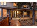 Inviting front entrance with stone accents and wooden walkway at 28735 Little Big Horn Dr, Evergreen, CO 80439