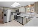 Bright kitchen with stainless steel appliances, white cabinets, and ample counter space at 28735 Little Big Horn Dr, Evergreen, CO 80439