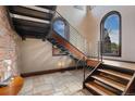 Modern staircase with wooden steps, stainless steel railings, and abundant natural light from large windows at 1376 S Clayton St, Denver, CO 80210