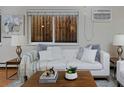 Comfortable living room with white sofa and wood coffee table at 1149 Columbine St # 104, Denver, CO 80206