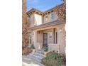 Two-story house with a light brown facade, a double door entry, and landscaping at 6725 S Versailles Way # 101, Aurora, CO 80016