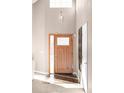 Inviting entryway with a wood door and hardwood floors at 9053 W 103Rd Ave, Broomfield, CO 80021