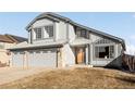 Two-story house featuring a three-car garage and manicured lawn at 9053 W 103Rd Ave, Broomfield, CO 80021