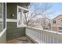 Small balcony overlooking the street with a white railing at 9452 Carlyle Park Pl, Highlands Ranch, CO 80129