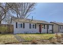 View of the home highlighting the red front door, neutral siding, and low-maintenance landscaping at 1120 Quince St, Denver, CO 80220