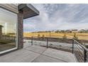 Private patio with metal railing offering scenic views of the community at 1234 S Algonquian St, Aurora, CO 80018