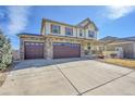 Home featuring a spacious driveway, a three-car garage, and a cozy covered porch at 18281 Keswick Ct, Parker, CO 80134