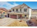 Charming two-story home with stone accents, a covered front porch, and a spacious two-car garage at 18281 Keswick Ct, Parker, CO 80134