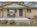 Inviting front porch with cozy seating, creates a welcoming entrance to this lovely home at 6661 Lamar St, Arvada, CO 80003